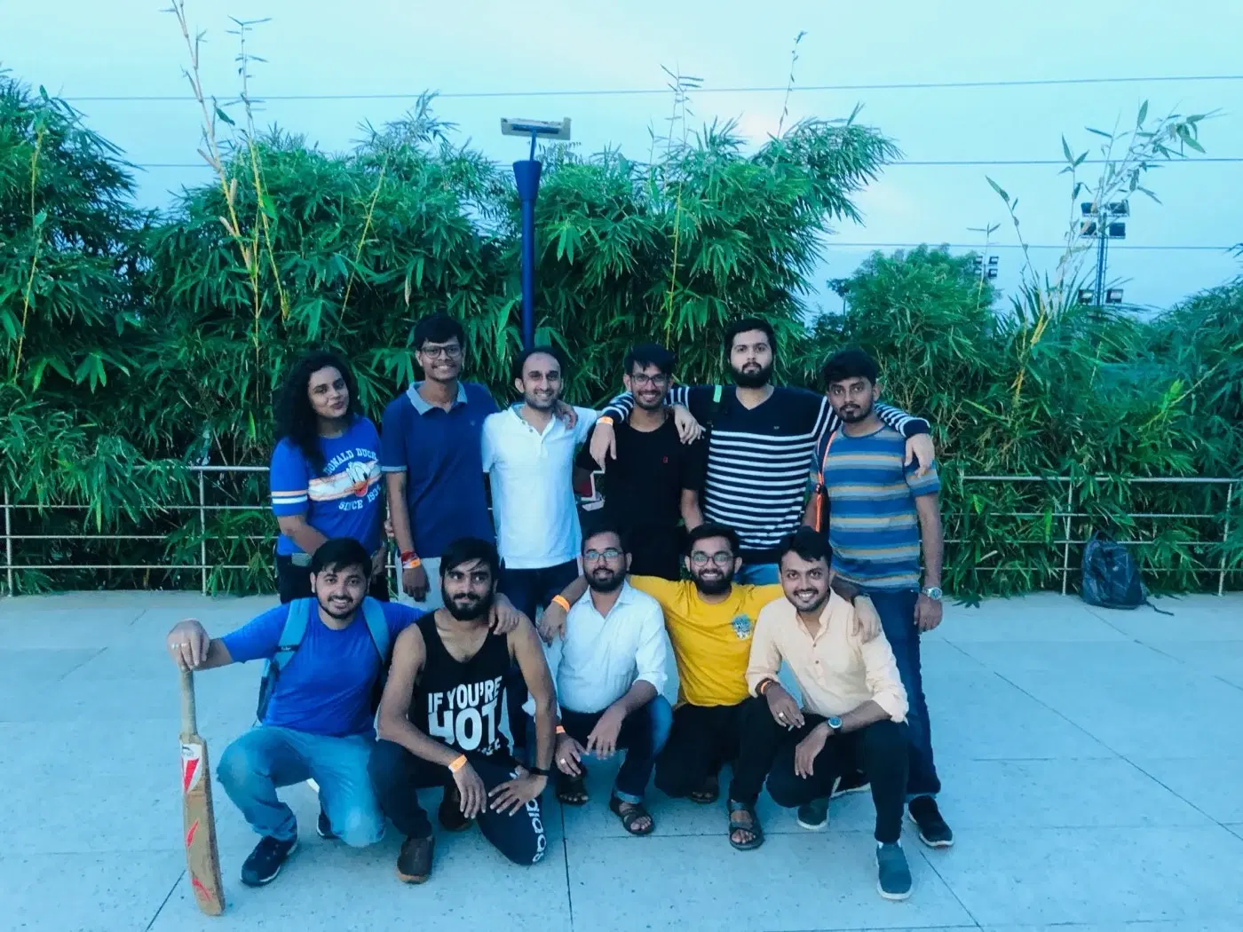 Nividata engineers with a cricket bat after an evening game